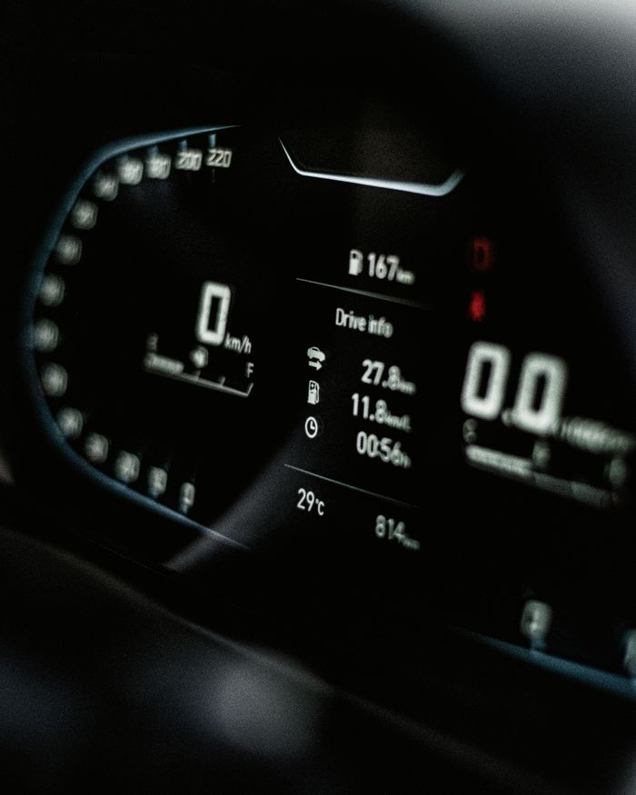 project-03-b Close-up of a sleek digital car dashboard displaying speed and drive info.